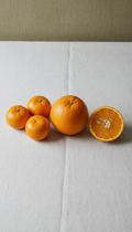 Amber citrus oranges on linen cloth
